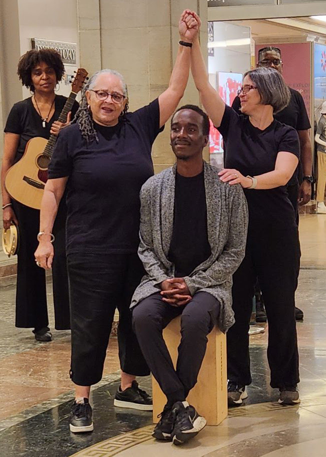 (Foreground from left to right) Pamela, Nous, and Erin, from improvisation group Verbal Gymnastics, reenact attendee Shannon Ross’s experience on what freedom means to her, during a performance at the National Archives, June 18, in celebration of Juneteenth. (National Archives photo by Brittney Meadors)