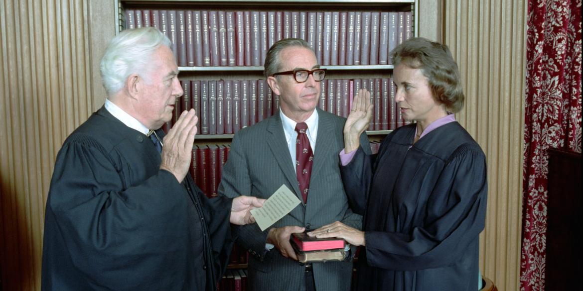 Sandra Day O'Connor being sworn in as a Supreme Court Justice by Chief Justice Warren Burger as her husband John O'Connor looks on, September 25, 1981. (NAID 276563289)